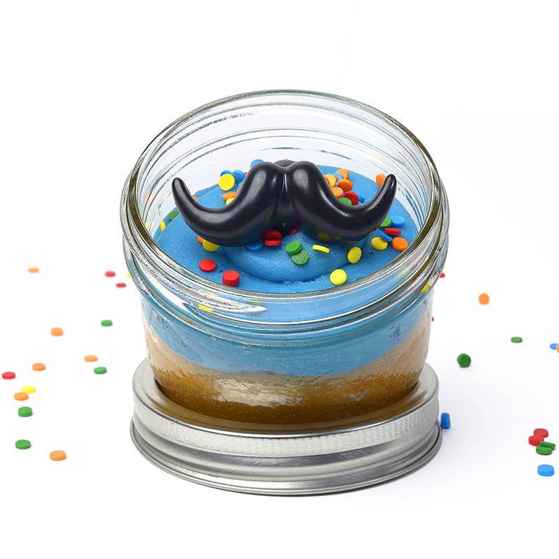 cupcake baked in a jar, jarcake with blue frosting and moustache plastic ring