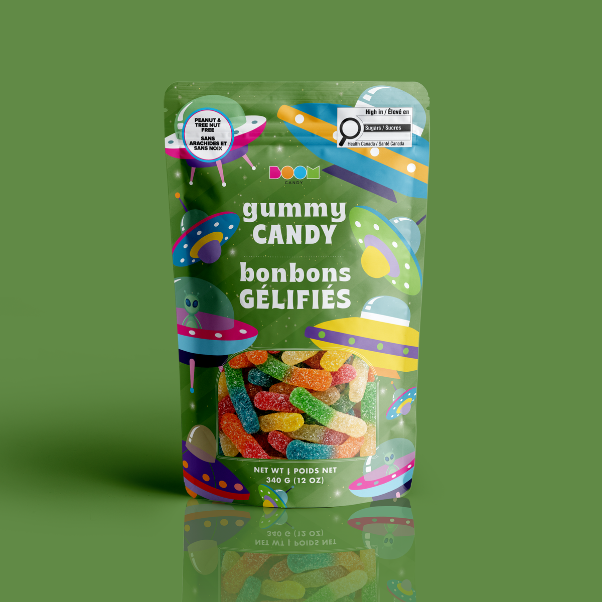 A bag of sour-dusted gummy worms in a green UFO and alien spaceship Halloween pouch, certified 100% peanut and tree nut free.