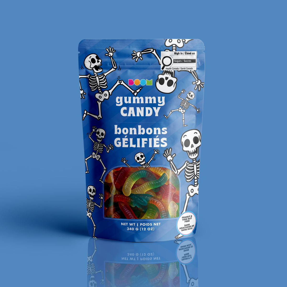 A bag of dual-toned gummy worms in a blue dancing skeletons Halloween pouch, certified 100% peanut and tree nut free.