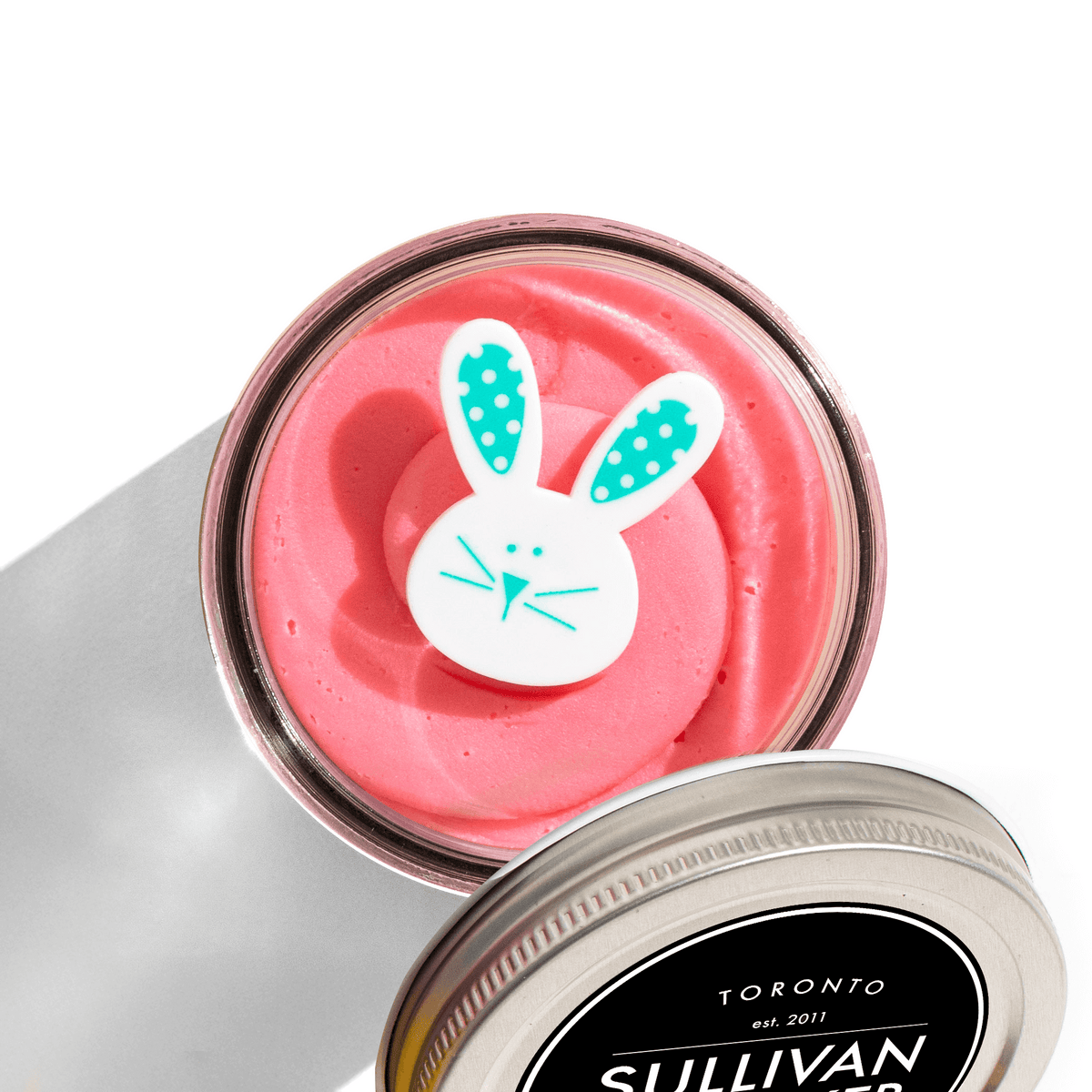 The Eggstra Special Easter Jarcake with pink and green frosting in a glass jar, nut-free Easter treat baked fresh in Toronto.