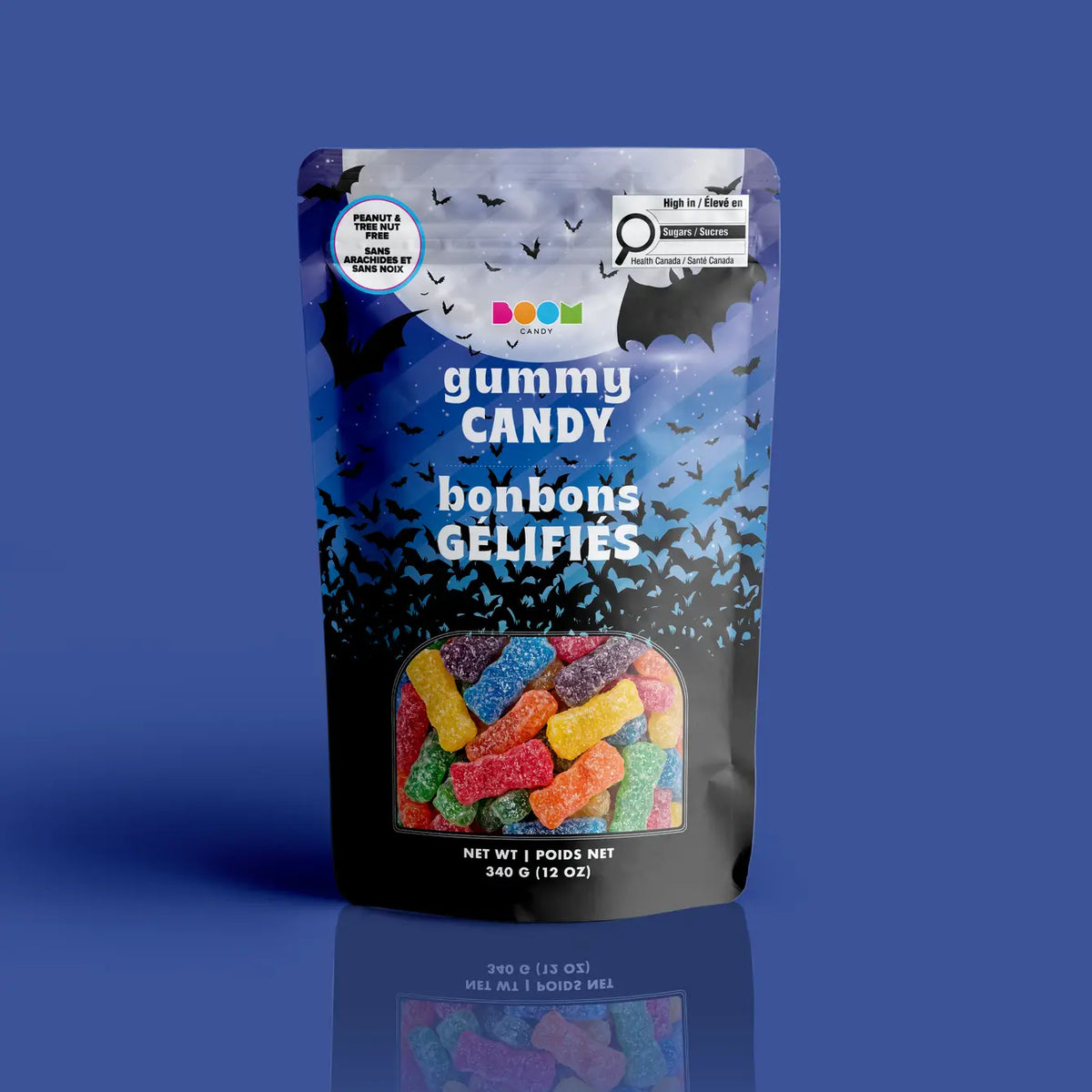 A bag of sour-dusted colorful Bud Bites gummies in a midnight blue flying bats and full moon Halloween pouch, certified 100% peanut and tree nut free.