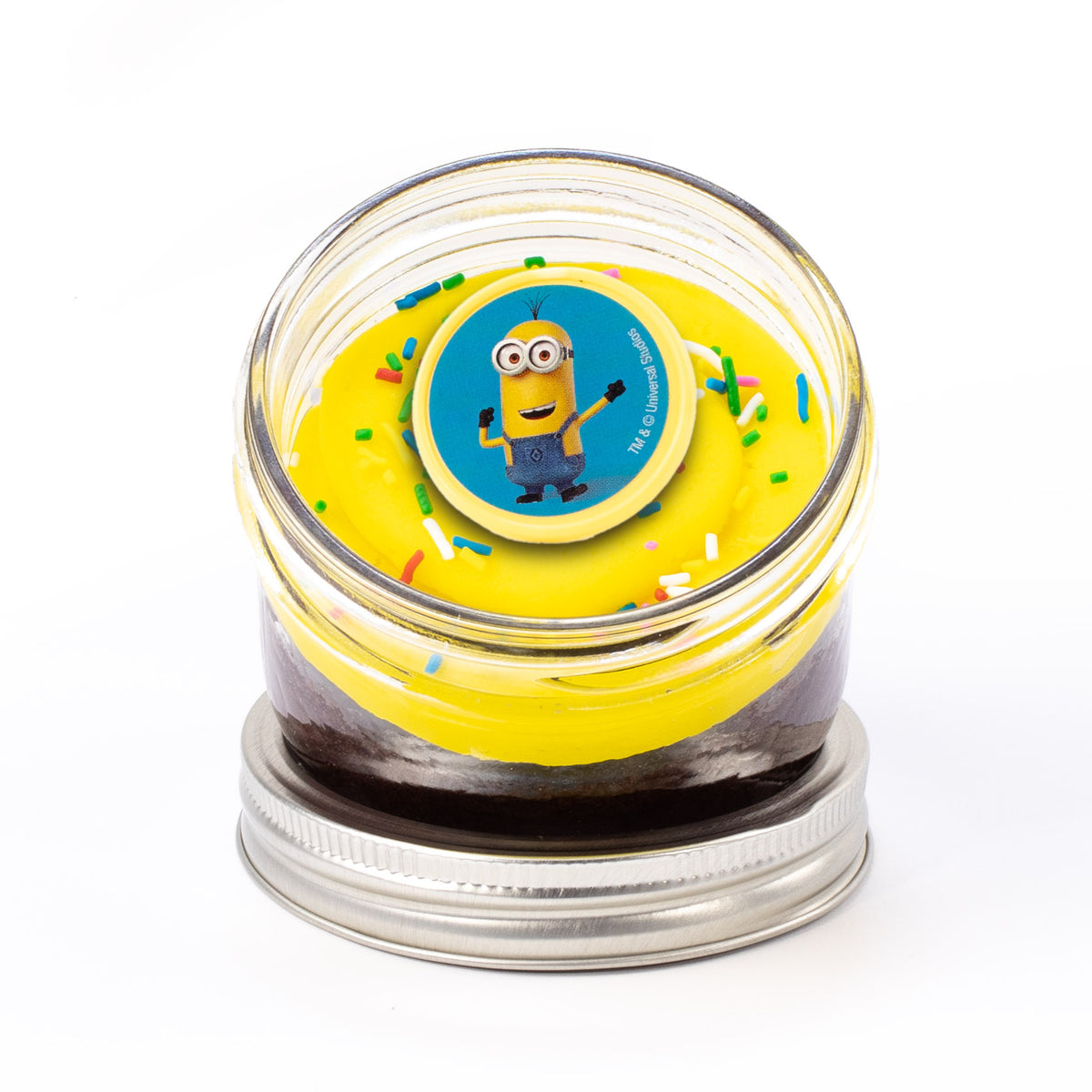 Minion Jarcake (Mini/Regular sizes) in a jar with personalized sticker option, yellow and blue frosting, and Minion ring for nut-free delivery in Toronto.