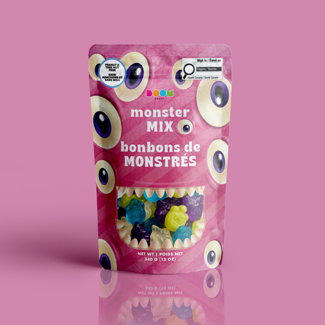 A bag of colourful monster gummies framed by a toothy mouth window in a pink eyeball monster Halloween pouch, certified 100% peanut and tree nut free.