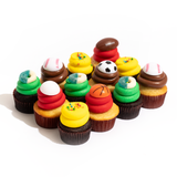 A dozen sports-themed nut-free cupcakes featuring vanilla and chocolate bases with red, green, yellow, and chocolate frosting, topped with sports balls and gummy rings.