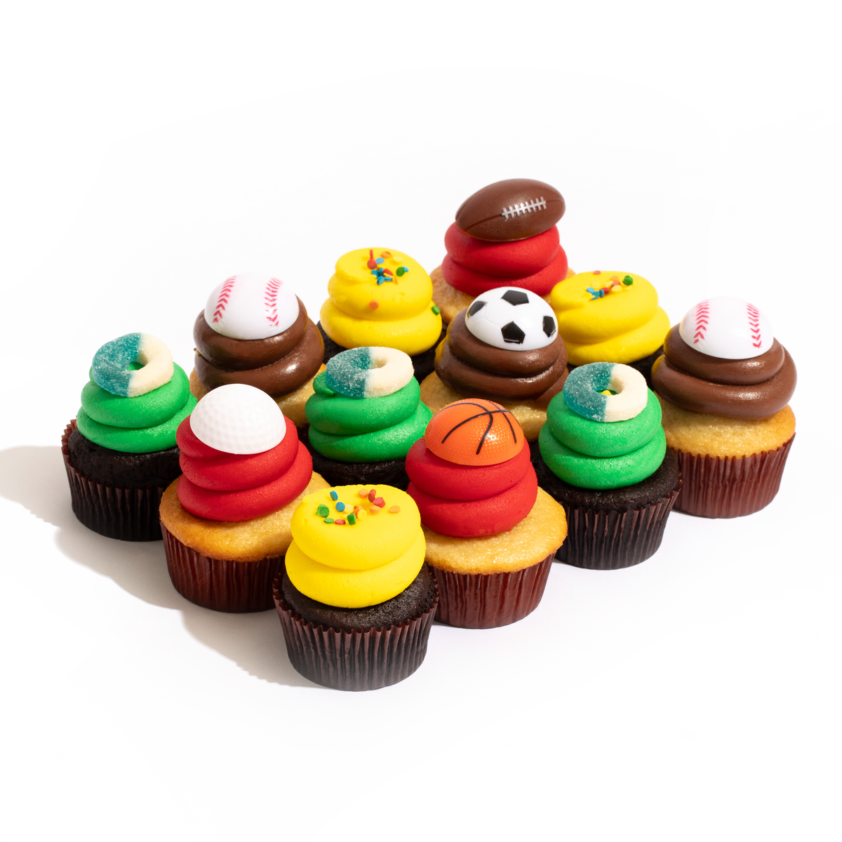 A dozen sports-themed nut-free cupcakes featuring vanilla and chocolate bases with red, green, yellow, and chocolate frosting, topped with sports balls and gummy rings.