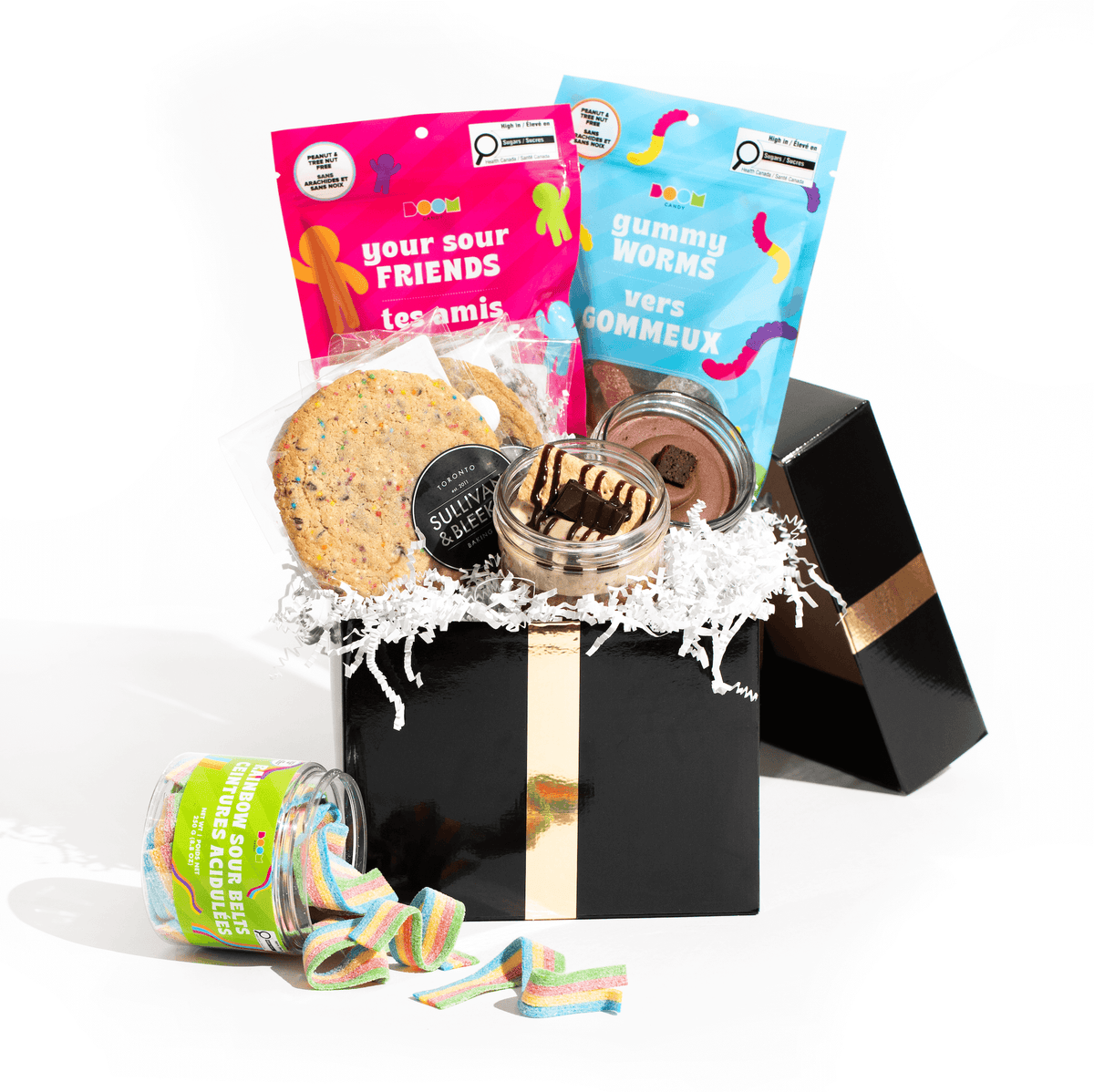 The Sweet Essentials Box, a gourmet gift set containing Jarcakes, individually wrapped cookies, and Boom Candy assortment, for delivery in Toronto.
