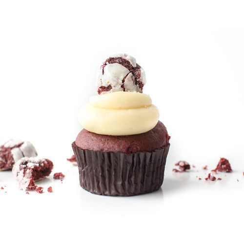 Single Red Velvet gourmet nut-free cupcake with cream cheese frosting and a tiny Red Velvet cookie on top for Toronto delivery.