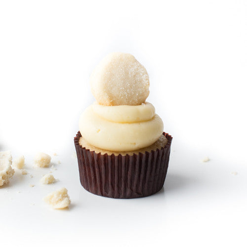 Single Vanilla gourmet nut-free cupcake with vanilla frosting and a homemade shortbread cookie on top for Toronto delivery.