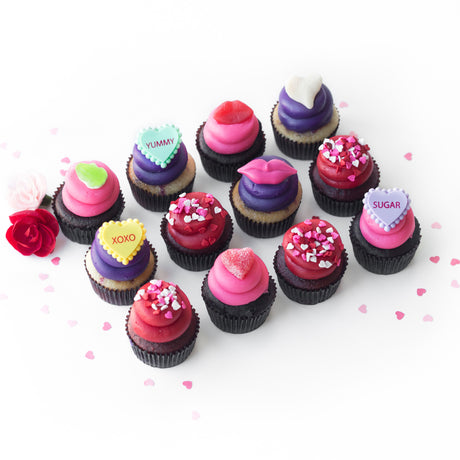 The Sealed With a Kiss Dozen 12 pack of nut-free cupcakes with pink and red heart decorations for romantic gift delivery in Toronto.	