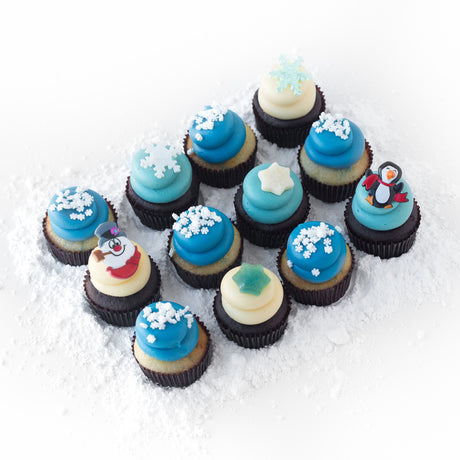 The Let It Snow Dozen 12 pack of nut-free cupcakes with blue and vanilla frosting and snowflake sprinkles for winter party delivery in Toronto.	