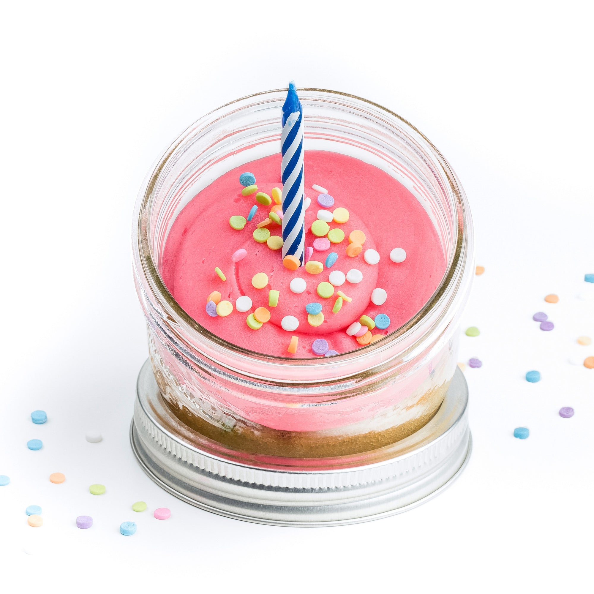Birthday Cake Jarcake (Mini/Regular sizes) in a jar with pink or blue frosting, sprinkles baked in, and a real candle for nut-free delivery in Toronto.