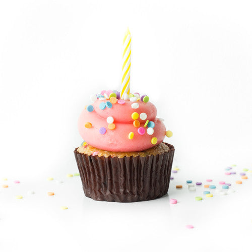 Single Birthday nut-free cupcake with pink frosting, sprinkles, and candle on top for an individual gift box or school lunch in Toronto.