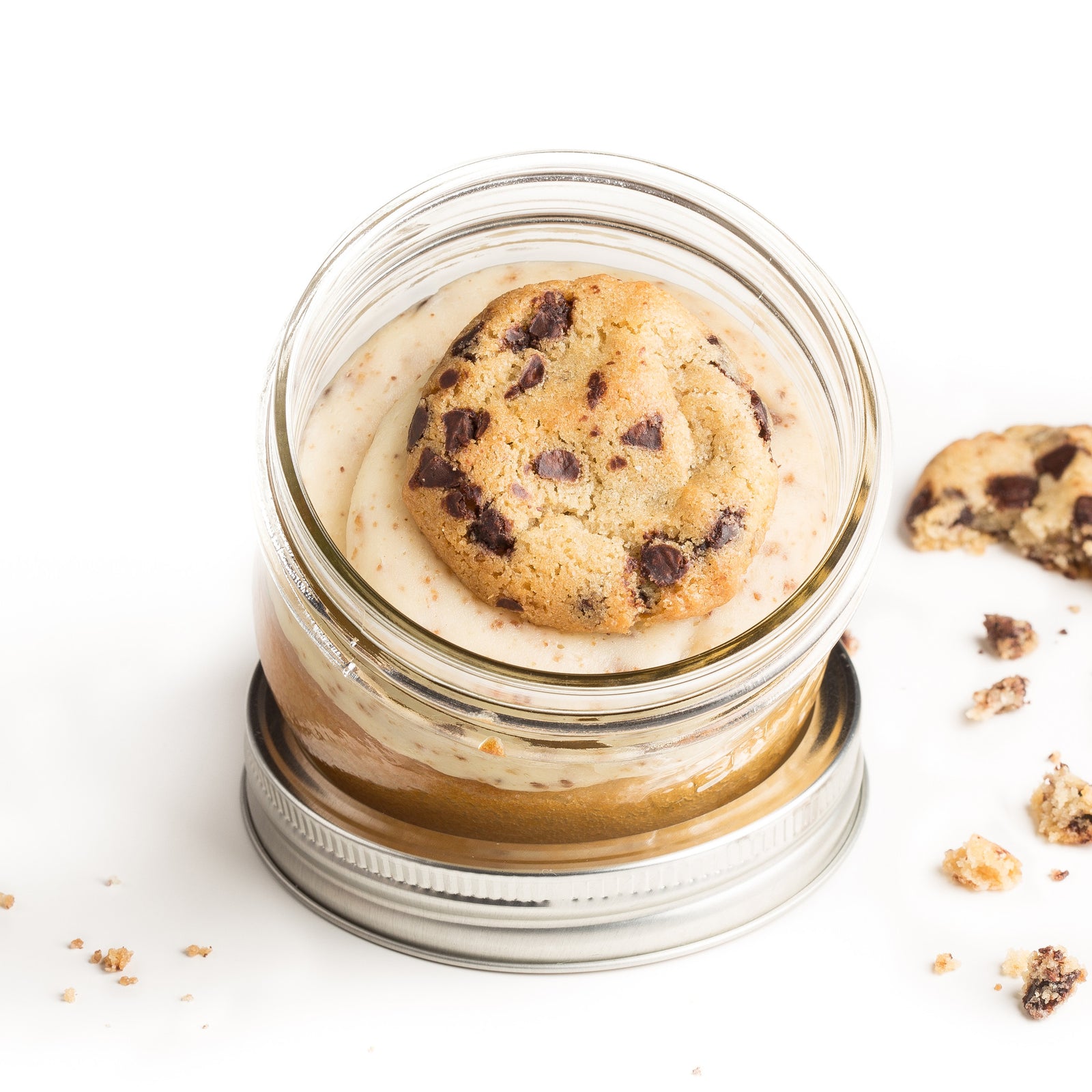 Cookie Dough Jarcake (available in Mini/Regular sizes) in a jar with personalized sticker option, edible cookie dough frosting and chocolate chip topping for nut-free delivery in Toronto.