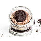 Cookies & Cream Jarcake (available in Mini/Regular sizes) in a jar with personalized sticker option, vanilla cream frosting, and crushed soft chocolate cookies for nut-free delivery in Toronto.