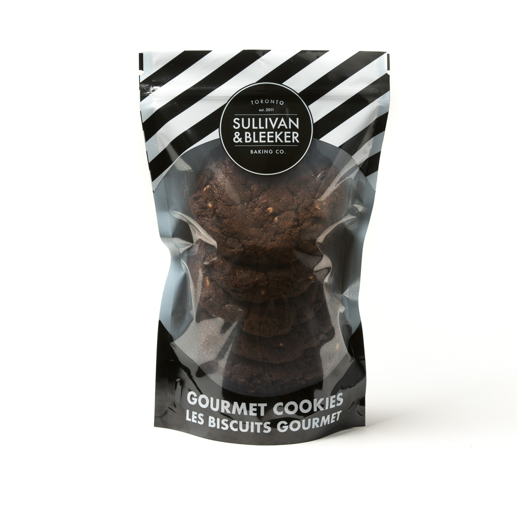 Six-pack of soft-baked Double Chocolate nut-free cookies in a resealable zip-top bag, loaded with milk, white, and semi-sweet chips.