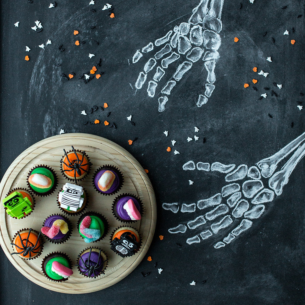 The Spooktacular Dozen nut-free chocolate and vanilla Halloween cupcakes with spooky candy and ring decorations for Toronto delivery