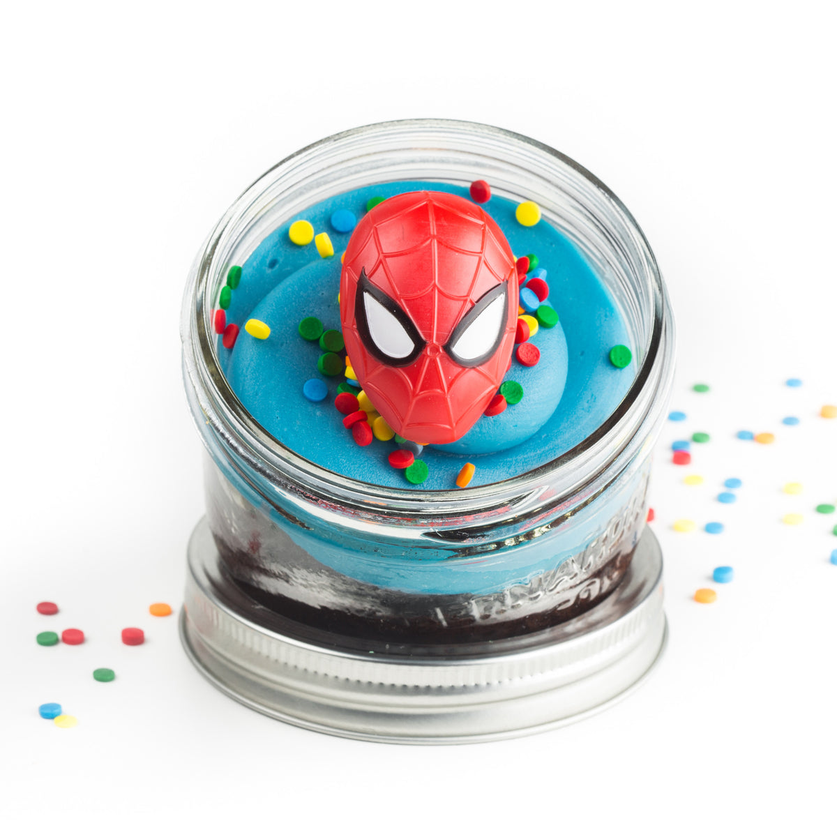 Superhero Jarcake (Mini/Regular sizes) in a jar with personalized sticker option, themed frosting, and Batman/Spider-Man ring for nut-free delivery in Toronto.
