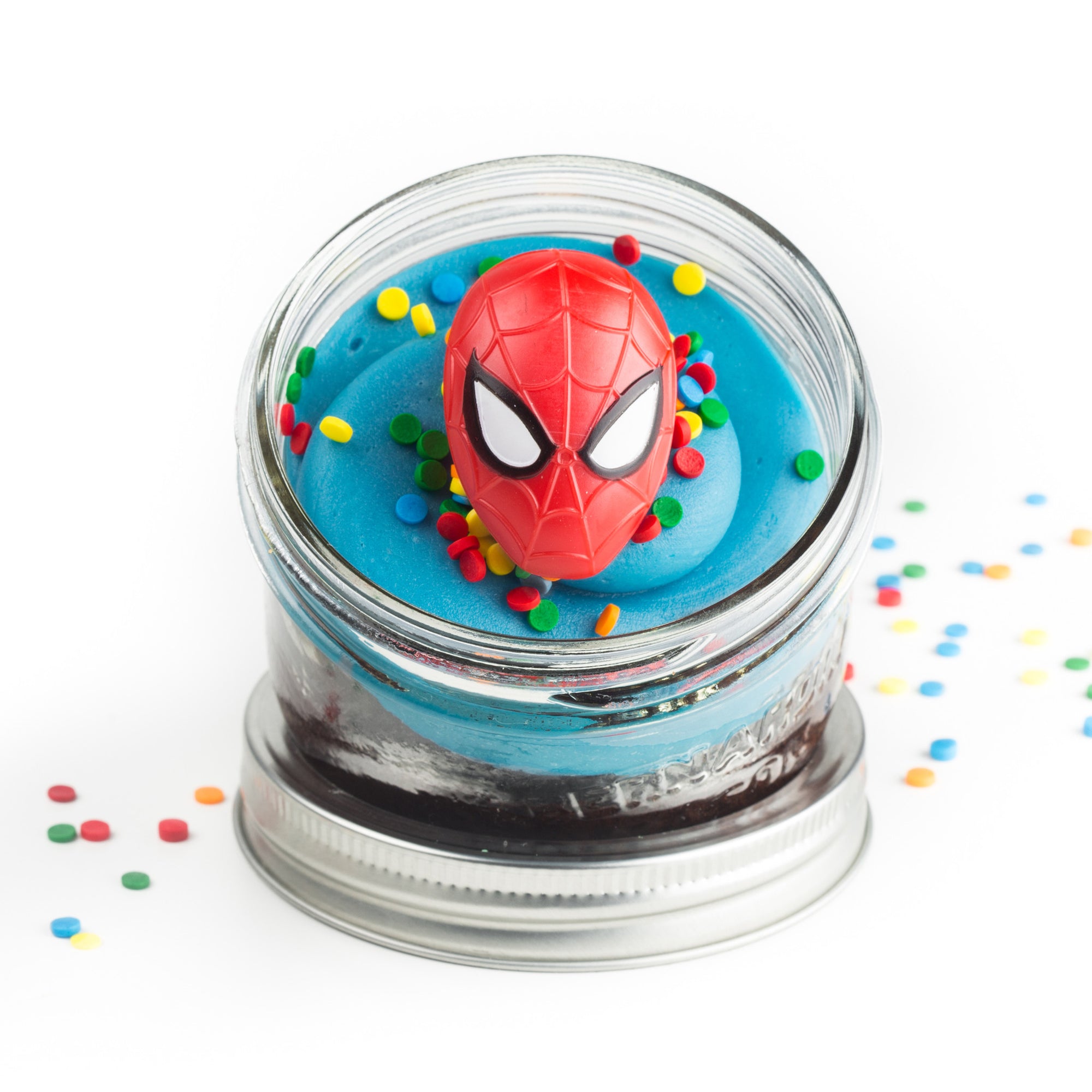 Superhero Jarcake (Mini/Regular sizes) in a jar with personalized sticker option, themed frosting, and Batman/Spider-Man ring for nut-free delivery in Toronto.