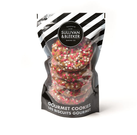 Six-pack of soft-baked Valentine's Day nut-free chocolate chip cookies in a resealable zip-top bag, topped with heart sprinkles for romantic gifts in Toronto.