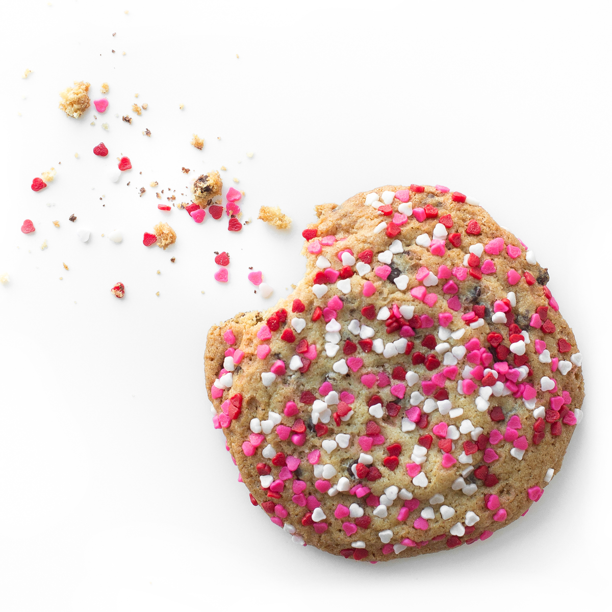 Single soft-baked Valentine's Day nut-free cookie, individually wrapped, topped with red and pink heart-shaped sprinkles for a romantic treat in Toronto.